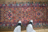 A personal view of the vibrant Henna plant pattern on an antique camel hair Serab runner.