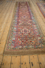 Angled perspective view of an antique Serab runner showcasing its full length and allover geometric pattern.