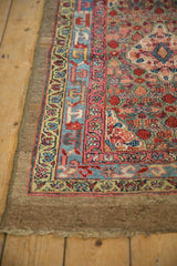 Angled view of an antique Serab runner's wide camel hair border and intricate, colorful guard bands.