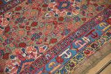 Detailed view of the hand-knotted pile on an antique camel hair Serab rug, contrasting the henna field with the sky blue border.