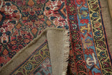 Detail of the secured edge and camel-colored hand-knotted foundation of an antique Serab rug.