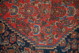 Antique Bijar rug detail: hand-knotted bird-like Herati motifs in cherry red, indigo, chestnut with even wear.