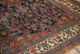 Antique Bijar rug close-up: hand-knotted Herati pattern, indigo, red, ivory, and even pile wear.