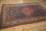 Antique Bijar rug lower corner, ivory border with red, blue Herati field motifs.