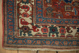 Antique Bijar rug corner with even wear, original red selvage, and detailed floral-geometric borders.