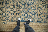 Antique Persian Malayer carpet's distressed indigo Herati pattern, revealing beige foundation.