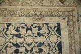 Distressed antique Malayer rug corner: abrashed Herati field in charcoal, beige, and bronze border.