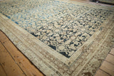 Antique distressed Persian Malayer corner, worn beige borders, faded Herati pattern on dark ground.