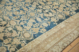Ornate beige border detail and distressed cobalt blue Herati field on an antique Malayer carpet.