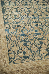 Textured antique Persian Malayer carpet with worn teal Herati pattern and beige border.