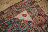 Ivory corner spandrel of an antique Hamadan rug featuring a singular boteh and geometric border.