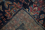 Folded corner of a vintage Lilihan runner contrasting the glossy wool pile with the hand-knotted back.