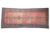 Antique Hamadan runner with a column of medallions over a hexagonal lattice field showing strong dusty red abrash.