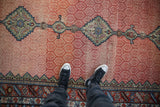 Central Samovar medallions and hexagonal lattice field of a hand-knotted antique Hamadan runner.