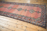 Antique Persian Hamadan runner seen at an angle, highlighting dramatic color abrashes on the field.
