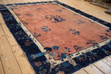 Navy blue and ivory border of an antique Peking rug, displaying a bird motif.