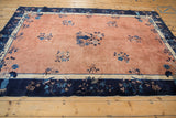 Antique Peking carpet, lower border detail with navy blue, sky blue florals, bird motifs, pale copper field.