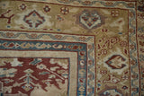 Corner of Antique Mahal rug; deep red field, ornate borders with floral arabesques, mauve tones.