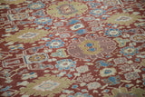 Repeating floral medallions and arabesques on Mahal carpet in black cherry red, dusty gold, sky blue.