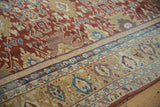 Close detail of repeating floral medallions and arabesques on an antique Persian Mahal carpet.