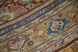 Antique Mahal carpet's red, blue, gold floral border patterns and fringe.