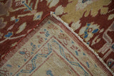 Corner detail of an antique Mahal carpet reveals the red pile and rose-toned reverse weave.