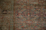 Close-up of an antique Fereghan carpet's even wear, revealing knot heads and the faint foundation.