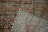 Folded corner of an antique Fereghan carpet showing the hand-knotted foundation and reverse weave.