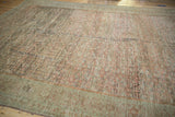 Close-up detail of the heavy abrash and low-pile texture on a distressed Fereghan carpet.
