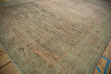 Time-softened ruby and dusty teal tones across the heavily abraded pile of an antique Fereghan.
