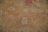 Close-up of the fine hand-knotted weave and knot heads on a distressed vintage Oushak carpet.