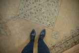 Time-softened low pile of a distressed Malayer carpet in camel and dusty powder blue.