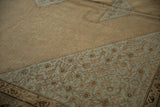 Close-up view of the worn, low pile texture of a distressed Malayer rug showing its knot heads.