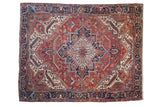 Vintage Persian Heriz carpet with a stepped diamond medallion in cherry red, navy, and powder blue.