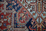 Hand-knotted pile of a vintage Heriz showing geometric serrated leaves in red, navy, and powder blue.