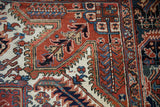 Close-up of the vintage Heriz carpet corner, showing serrated leaves and a geometric border.