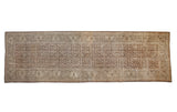 Vintage Distressed Persian Mahal carpet, repeating shrub motif in coffee brown, sand, and ivory, with aged texture.