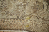 Distressed Mahal carpet close-up, featuring heavy wear, exposed foundation, beige, brown, and yellow.