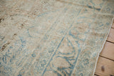 Intact side selvage and low pile texture of a distressed antique Persian Kerman rug.