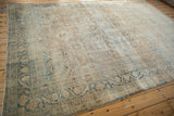 A perspective view of the distressed Kerman's soft, blanket-like feel and muted floral designs.