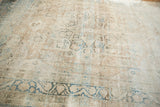 Angled view showing the soft, time-worn texture of a distressed antique Kerman rug.