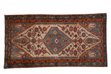 Vintage Hamadan rug: blue hexagonal medallion, cypress finials, beige field, red boteh border.