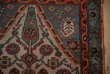 Vintage Hamadan rug detail: madder root red boteh border, dusty blue, beige field motifs.