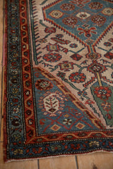 Traditional hand-knotted Hamadan rug detail: madder root red border, dusty blue boteh and serrated field.