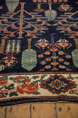 Persian Baktiari rug detail: Navy Garden of Paradise motif with cypress trees and a floral border.