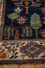 Vintage Persian Baktiari runner: beige border, navy field, cypress, and weeping willow motif.