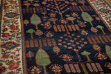 Navy field of vintage Baktiari rug with Garden of Paradise trees and vibrant floral border.