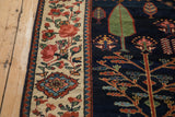 Cochineal red floral vines on beige border, with navy blue field and tree of life design.