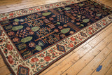 Baktiari runner detail: navy Garden of Paradise field with cypress trees and beige floral border.