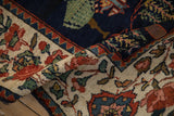 Folded vintage Baktiari runner: green tree of life motif, red, rose, beige floral border.